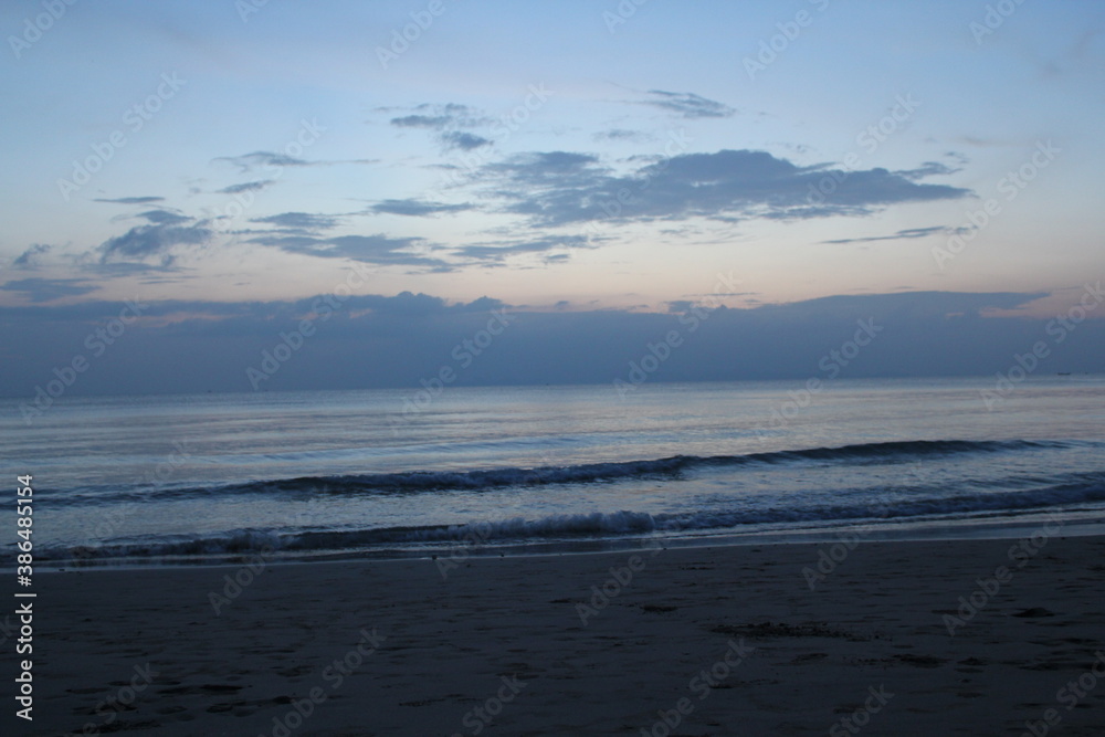 horizontal line of deep blue calm sky and sea after sunset on a beach in thailand