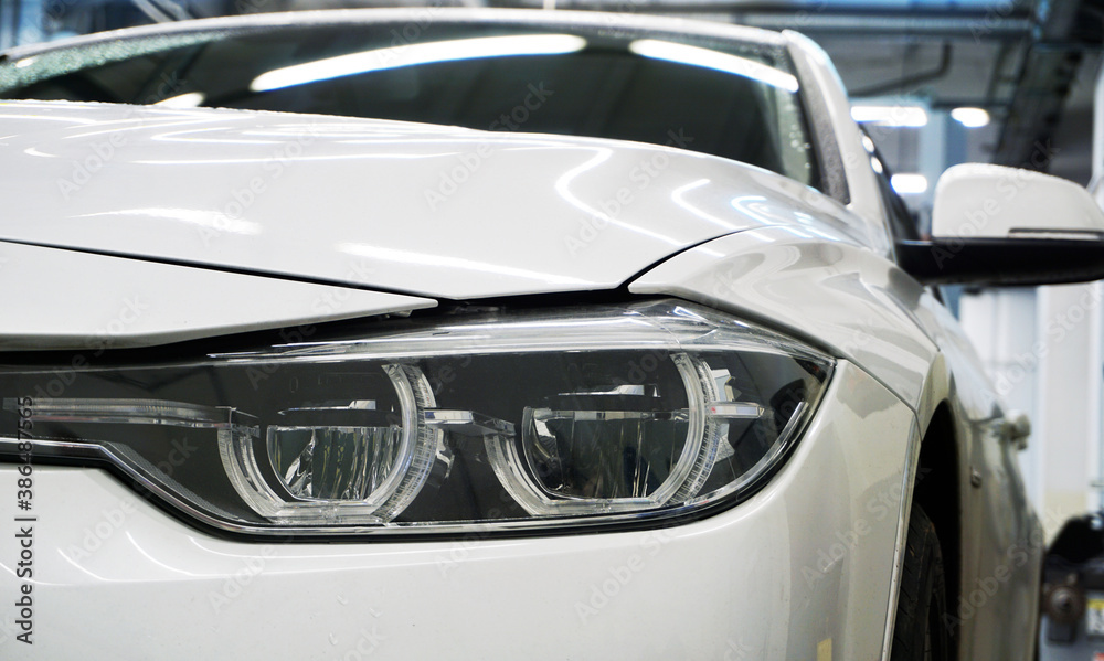 Headlight of a new luxury car close-up.