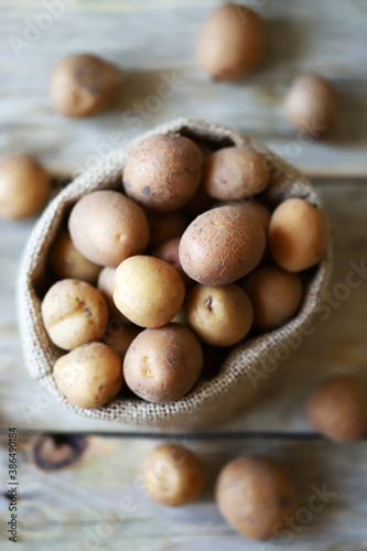 Selective focus. Mini potatoes in a small bucket. Eco friendly concept. Farm products.