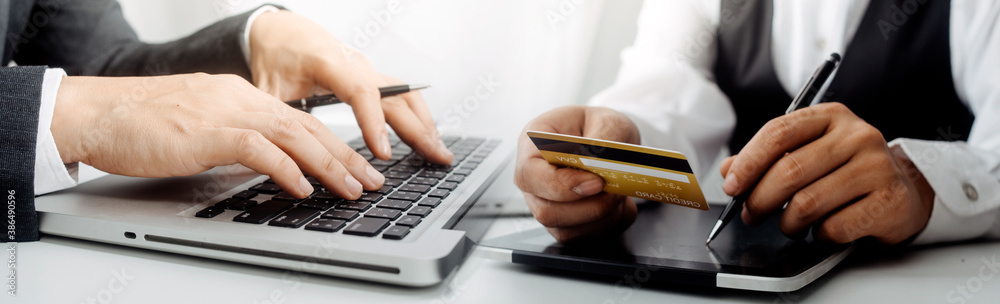 businesswoman hand using smart phone, tablet payments and holding credit card online shopping, omni channel, digital tablet docking keyboard computer at office in sun light businesswoman hand using smart phone, tablet payments and holding credit card online shopping, omni channel, digital tablet docking keyboard computer at office in sun light