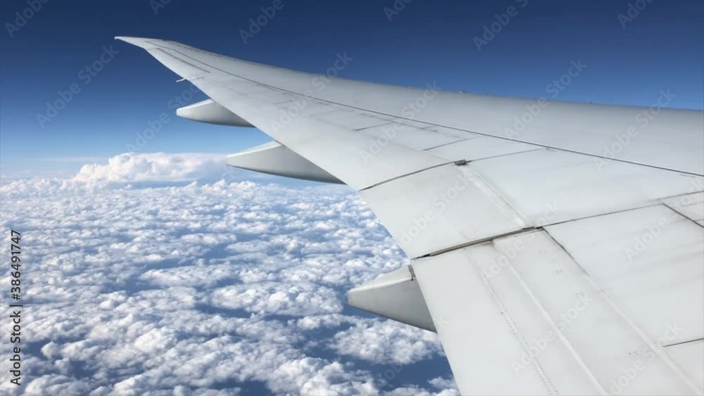 Wing of the airplane against cloudy sky Wing of the airplane against cloudy sky