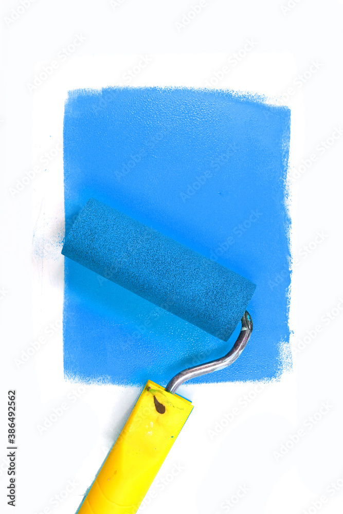 Obraz premium Painting a rough wall with roller. Paint roller leaving stroke of white color over a rustic background. usable for text and messages.