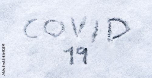 Covid 19 written in the snow. Covid 19 text written in the snow. Concept of covid-19 pandemic in winter and christmas 2020.
