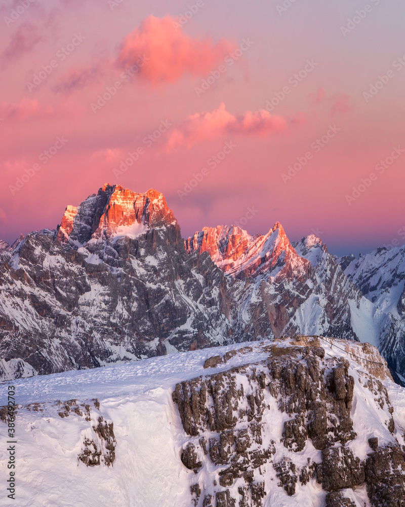 Dolomites. Winter mountains. Sunset. Enrosadira effect. Snow mountains. The peak of mount Pelmo, postcard view, Alps.