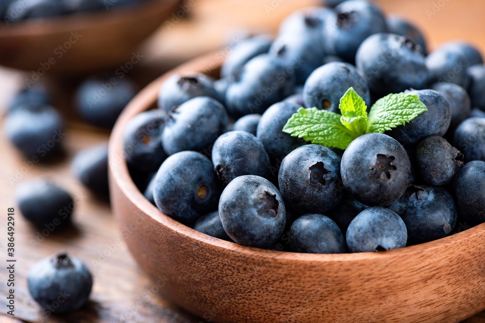 Blueberries in a wooden bowl, closeup view Blueberries in a wooden bowl, closeup view