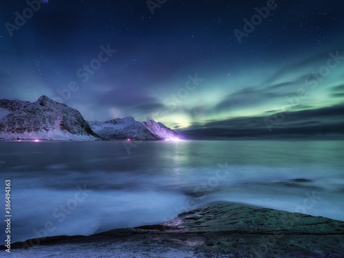 Aurora borealis on Lofoten islands, Norway. Green northern lights above mountains. Night winter landscape with aurora. Natural background in the Norway. © biletskiyevgeniy.com