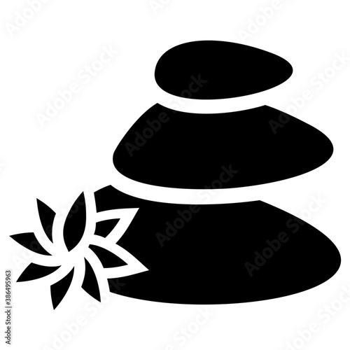 
Natural stones in black color placed with daisy aside, pebbles 
