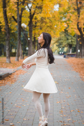 Beautiful girl ballerina dancing in the autumn city © bisonov