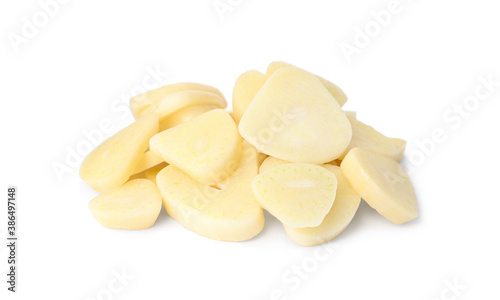 Pile of fresh sliced garlic cloves isolated on white. Organic food