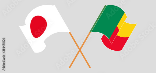Crossed and waving flags of Benin and Japan