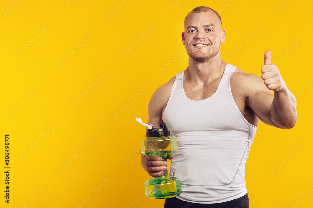 Studio portrait of muscular man with water bottle Studio portrait of muscular man with water bottle