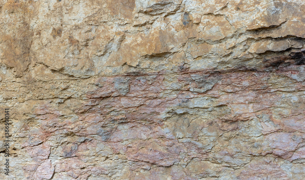 Obraz premium Natural mountain stone,a section of rock texture on a Sunny day.
