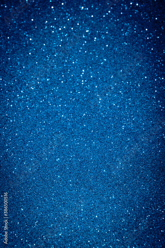 Abstract blue blurred sparkling background with focused area. Holiday festive concept. Glitter confetti. Christmas lights. 