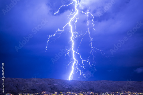 Huge and strong lightning strike at night during a severe thunderstorm