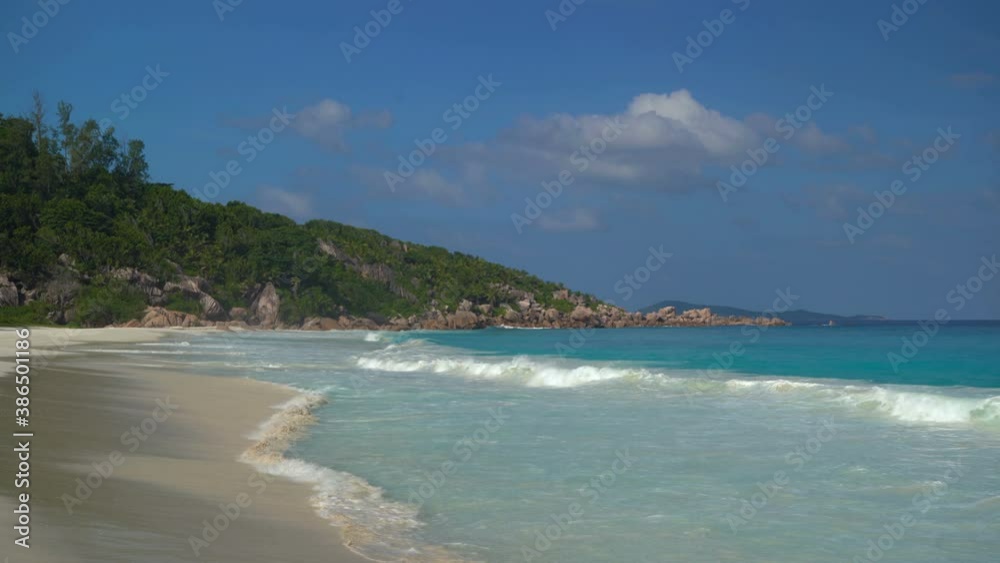 Beautiful beach on the shore with blue sky and clouds