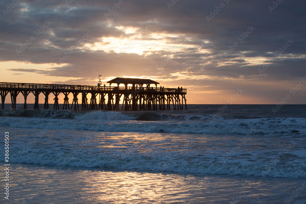 Sunrise with a fishing pier at the ocean Sunrise with a fishing pier at the ocean