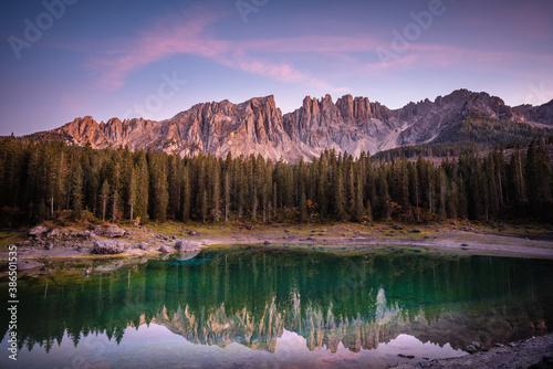 amazing mountains and lake at sunset time, with perfect reflection in Dolomites, Italy