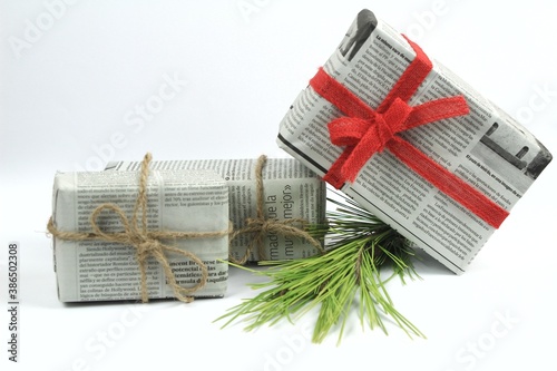 Bilde på lerret Gifts wrapped in old newspaper on white background