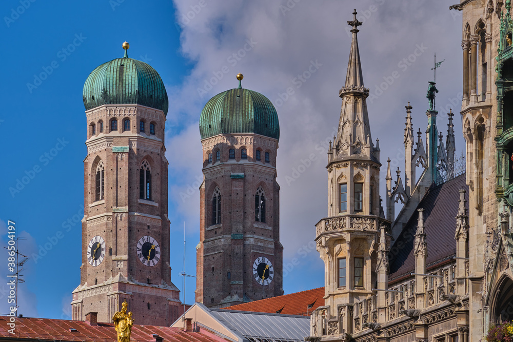 Towers of Frauenkirche church (Cathedral of Our Dear Lady) and detail of the Neues Rathaus (New Town Hall) in Munich, Germany