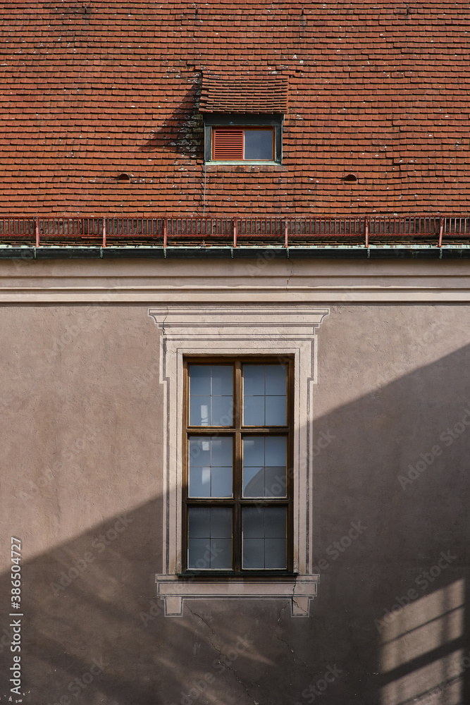 Windows, red roof, and shadow on the house