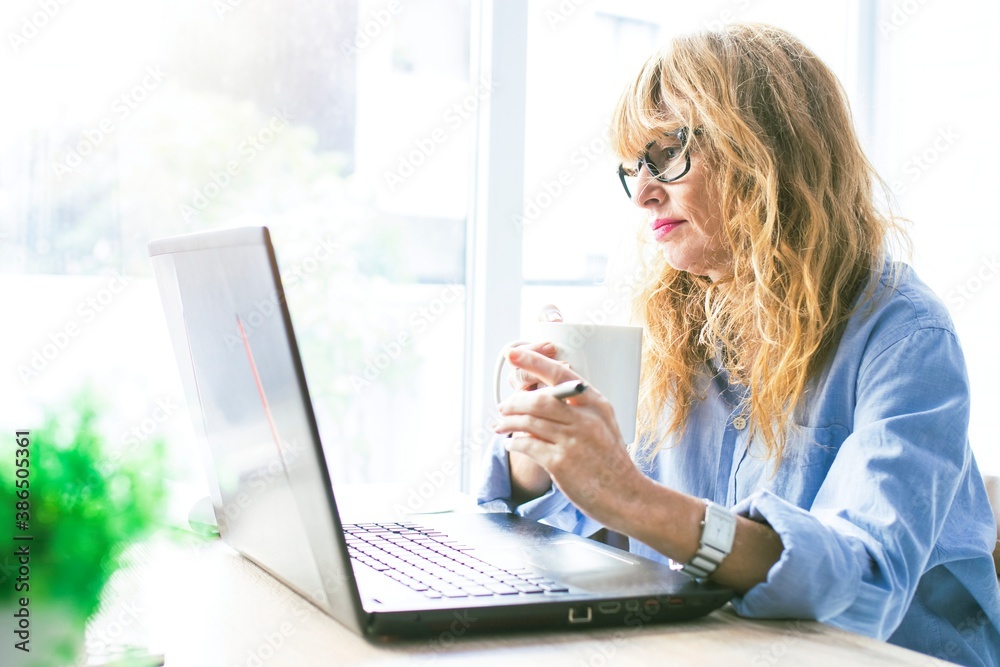 business woman with laptop and cup of coffee at home business woman with laptop and cup of coffee at home