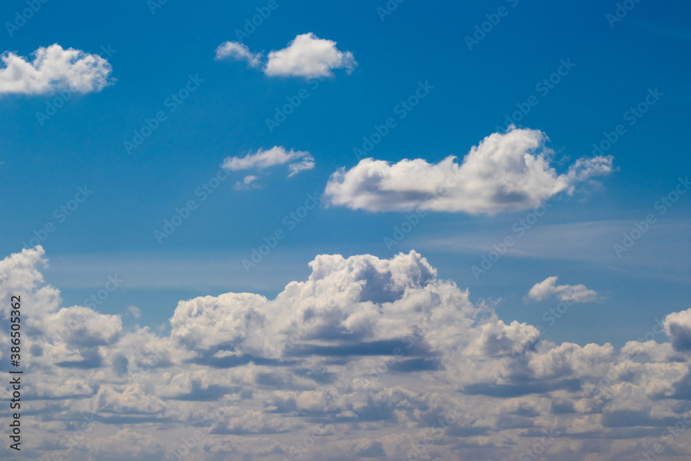 Small white cumulus clouds in the blue sky Small white cumulus clouds in the blue sky