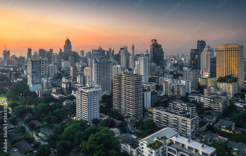 Cityscape of Bangkok, Thailand with Public Park and Skyscrapers at Sunset