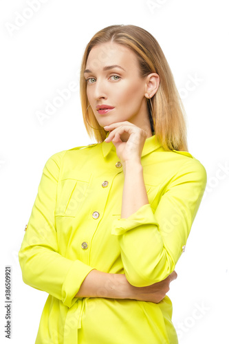Φωτογραφία Studio portrait of a young adult woman with straight fair hair and nude make-up posing in buttoned up lemon yellow blouse or dress