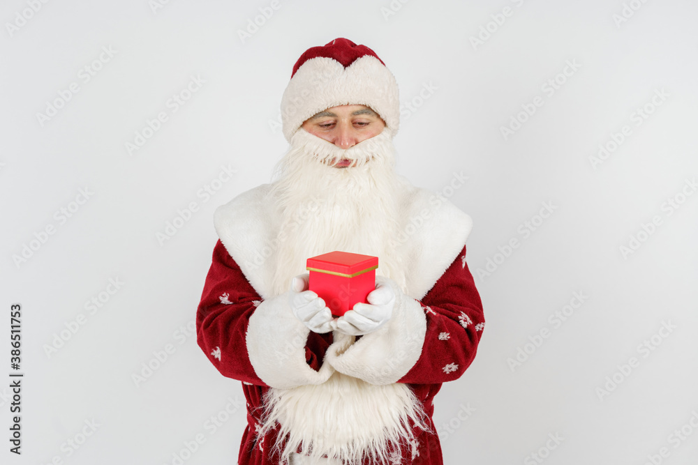 Santa Claus holds gifts in his hands. Isolated on white Santa Claus holds gifts in his hands. Isolated on white