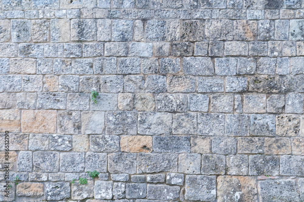 Old wall texture. Granite stone bricks pattern, natural construction material 