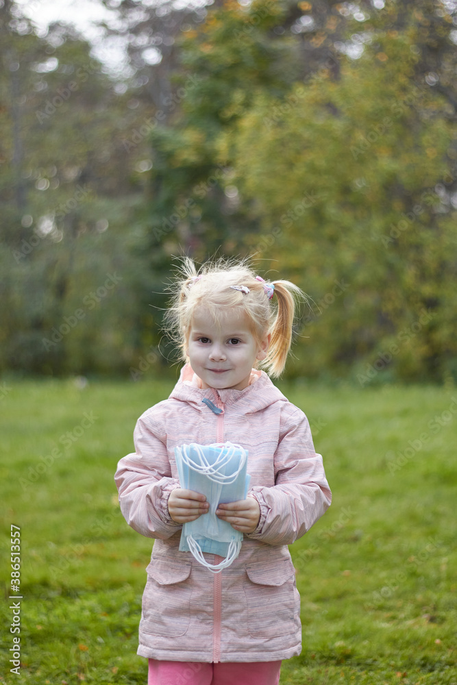 Baby throws out medical masks in nature