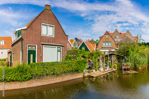 Old streets in Volendam, old traditional fishing village, typical wooden houses architecture