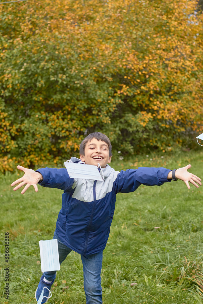 Boy throws out medical mask, concept of the end of coronavirus Boy throws out medical mask, concept of the end of coronavirus