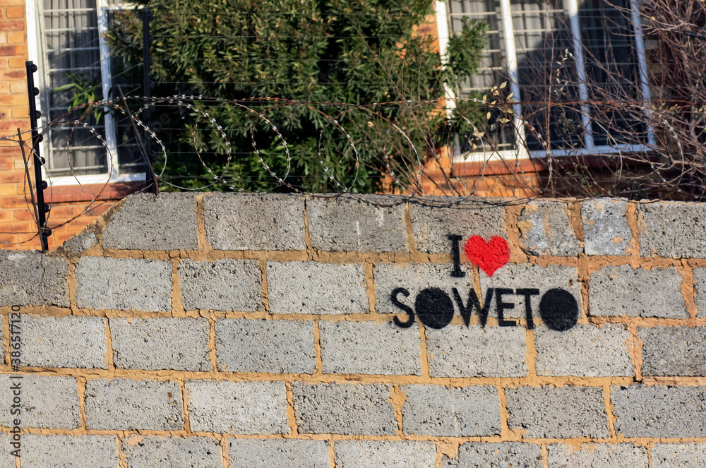 Fototapeta premium I LAVE SOWETO - an inscription on a fence with barbed wire. Black lives matter.