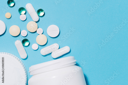 tablets and pills and capsules on a blue background .