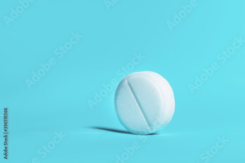 large white tablet on a blue background .