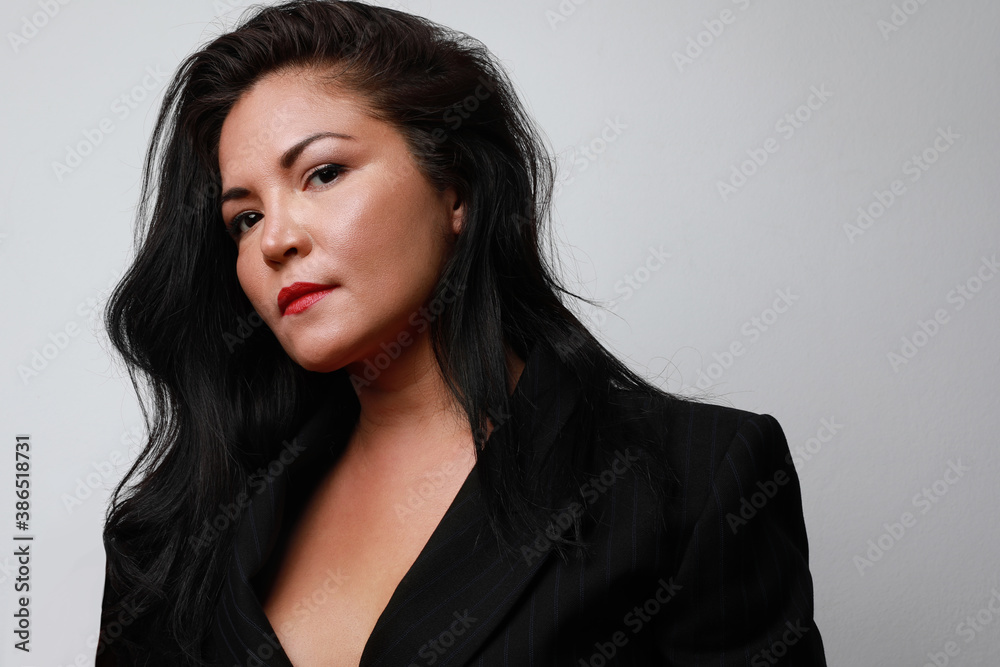 Portrait of attractive latin woman with long hair, posing over white background wall. Space for text. Portrait of attractive latin woman with long hair, posing over white background wall. Space for text.