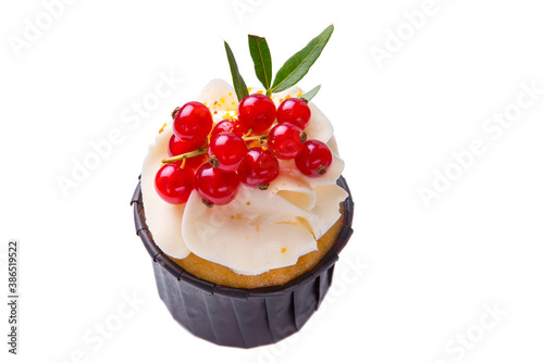 Sponge cake with cream and red currant on a white isolated background. Copy space