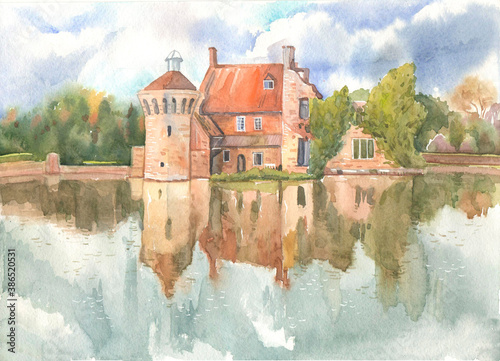 Old Skotney Castle and its surrounding park are reflected in the lake water on an autumn day, this is a watercolor drawing on paper. Old English country castle in Kent on the Bewl River photo