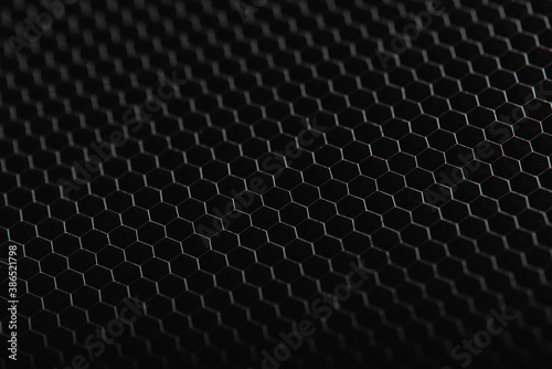 Plastic, metal hexagonal texture. Industrial mesh background. Low key with selective focus