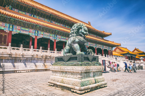 China travel destination background Beijing city famous ancient building architecture old temple with metal lion statue. Summer Asia vacation.