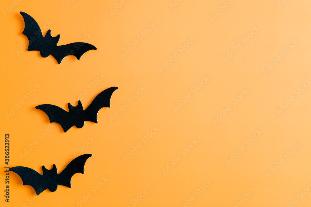 Fototapeta premium Halloween. Bats on an orange background. Halloween. Halloween concept.