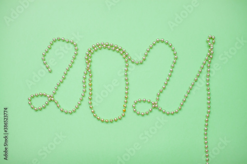 Happy New year 2021 celebration. Inscription 2021 from gold shiny new year beads