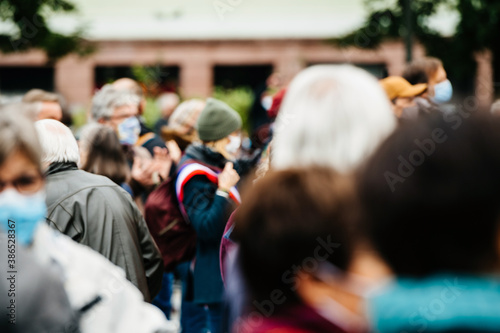 Wallpaper Mural Defocused view of unrecognizable large crowd of people gathering in the central square during a protest wearing blue surgical protection masks Torontodigital.ca