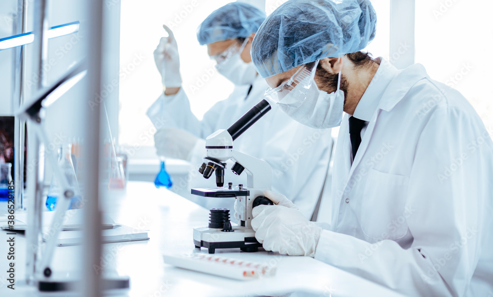 close up. scientist using a microscope in the laboratory . close up. scientist using a microscope in the laboratory .