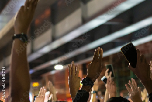 Protesters show three finger salute symbolic gestures at Democracy Monument to protest against the government photo