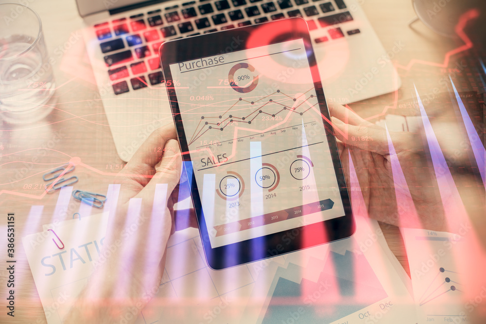 Double exposure of man's hands holding and using a digital device and forex graph drawing. Financial market concept. Double exposure of man's hands holding and using a digital device and forex graph drawing. Financial market concept.