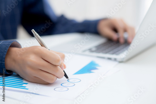 Hand of business man pointing document data graph and chart with pen, marketing and investment, report of statistics profit for financial, economic and growth of finance, management and planning.