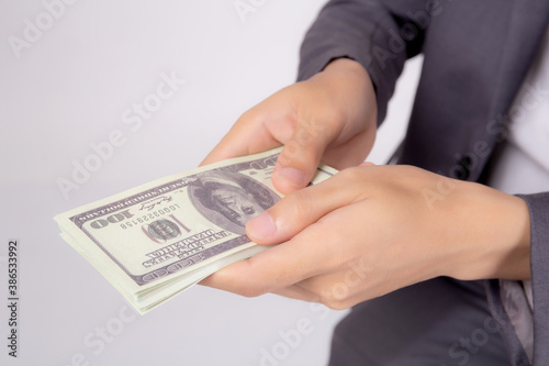 Hand of business man giving money isolated on white background, finance and cash, businessman holding banknotes dollar, deposit and loans, profit bonus and success, currency and exchange.