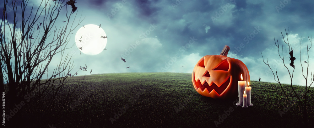 Jack O 'Lanterns with glowing eyes on spooky Halloween night under full ...
